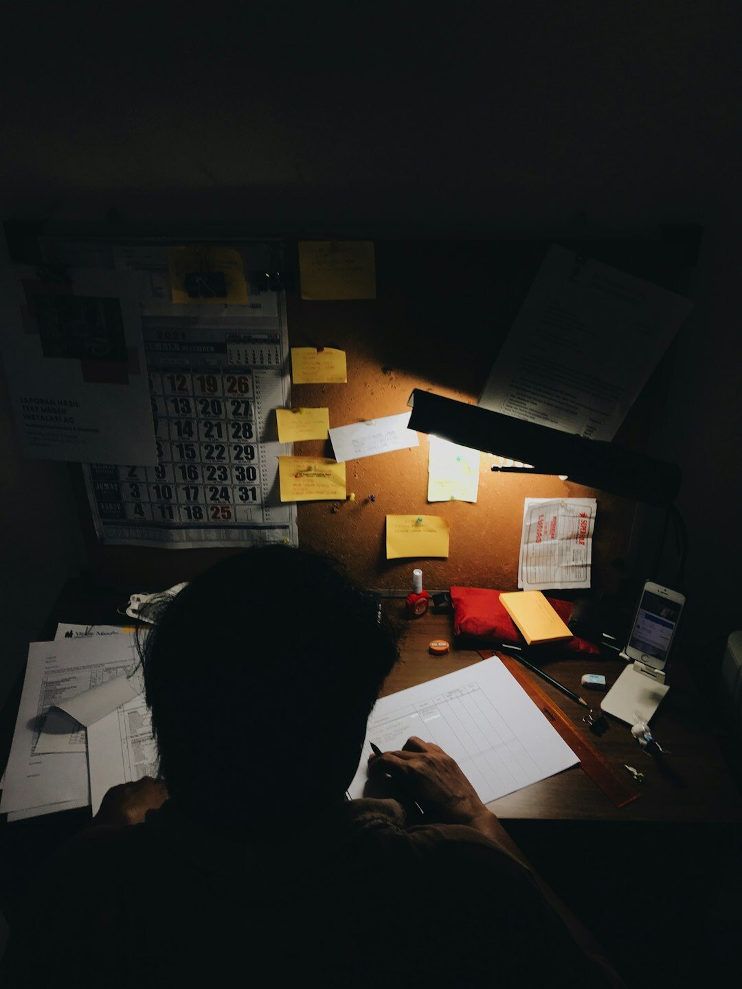 person sorting stamps at desk